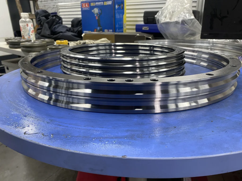 Circular guide components of different sizes arranged on a blue workbench