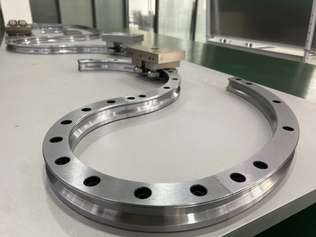 Close view of a curved guide segment, working face and mounting holes