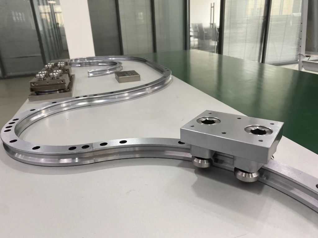 A carriage plate fitted to a curved rail on a demonstration workbench