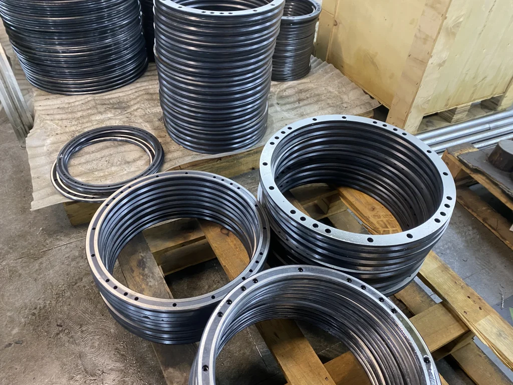 Circular guide components grouped on a pallet in the workshop