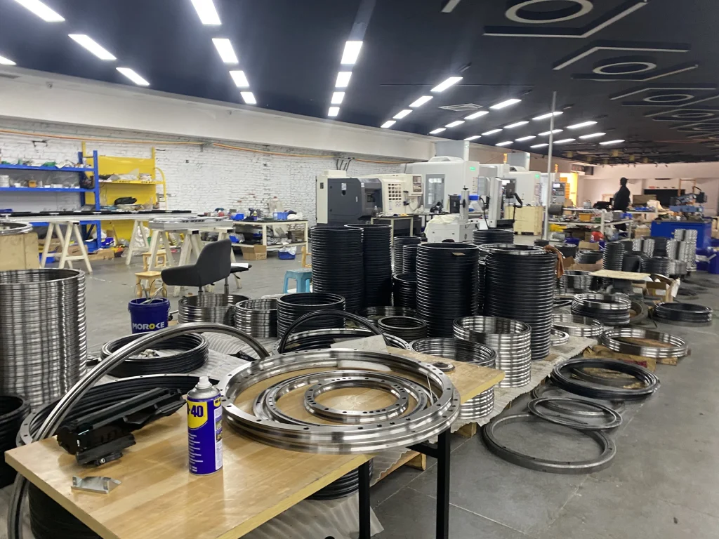SANJ workshop with circular rail components, workbenches and production equipment